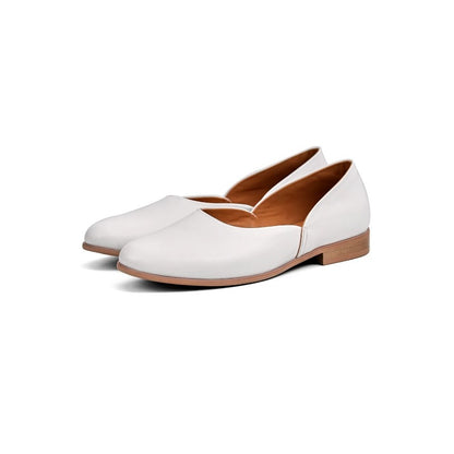 Lunepebbla black leather pointed-toe loafers worn with dark trousers showing pointed toe detail